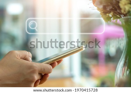 Women hand using smartphone do online shopping communication icons and search bar in internet. Social media maketing concept.