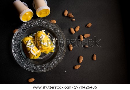 Kulfi is an Indian frozen dessert or you can say Ice Cream. Mango kulfi is an Indianized version of Mango ice cream made with mango pulp , sugar, Cream, Nuts, Pistachio etc.  Royalty-Free Stock Photo #1970426486