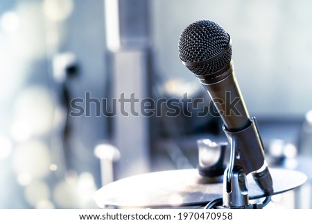 selective focus microphone and blur musical equipment,  drum on background.