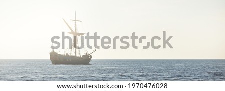 18th century sailing yacht in an open sea at sunset, close-up. Holland. Old tall ship. Recreation, vacations, cruise, historical reenactment, past, history