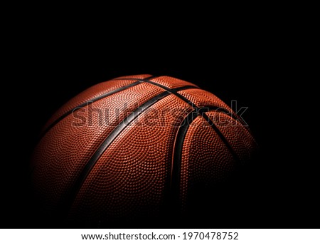 Beautiful basketball ball of orange color close-up on a dark background.