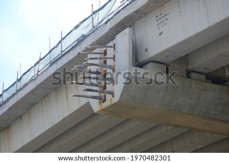Pictures of an under construction overhead bridge and its surroundings. 