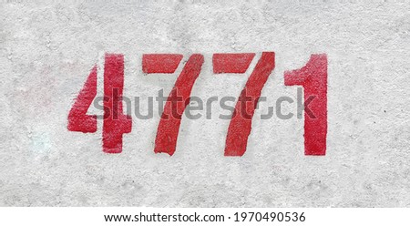 Red Number 4771 on the white wall. Spray paint.