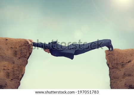 businessman between a rock and a hard space Royalty-Free Stock Photo #197051783