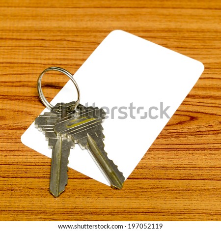business card and keys on wood background