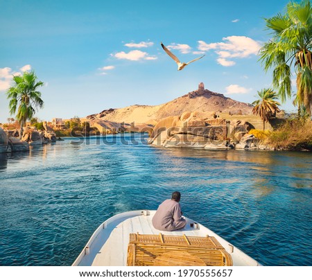 Boat driving on river Nile in Aswan, Egypt Royalty-Free Stock Photo #1970555657