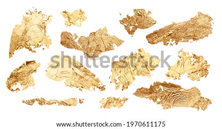 Gold glitter and bronze color blot. Abstract torn piece of metal leaf (potal) paper on white background. Collection. Royalty-Free Stock Photo #1970611175