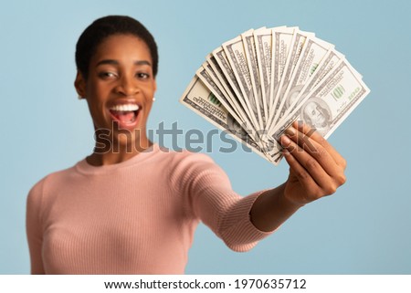 Big Prize. Happy Young African American Woman Demonstrating Dollar Cash Fan At Camera, Cheerful Excited Black Female Holding Lots Of Money, Standing Isolated Over Blue Background, Closeup Shot