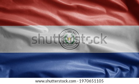 Paraguayan flag waving in the wind. Close up of Paraguay banner blowing, soft and smooth silk. Cloth fabric texture ensign background.