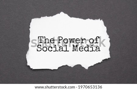 THE POWER OF SOCIAL MEDIA sign on the torn paper on the black background