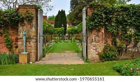 Garden Gate with Plants and Statue.	
 Royalty-Free Stock Photo #1970655161