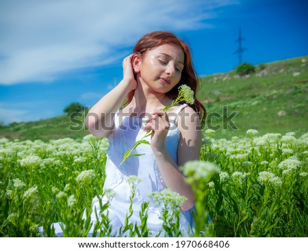 pretty girl in a field of flowers with beautiful flowers, woman in the garden, woman in a field