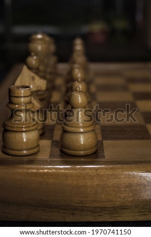 Chess pieces photoshoot, soft focus in the background, dark background