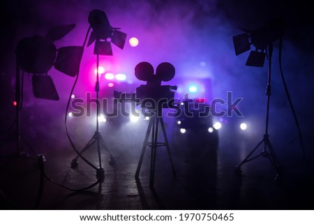 Action movie concept. Police cars and miniature movie set on dark toned background with fog. Police car chasing a car at night. Scene of crime accident. Selective focus Royalty-Free Stock Photo #1970750465