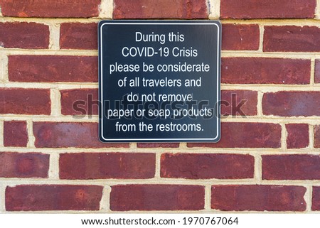 sign at a highway rest stop asking travelers not to remove paper and soap products from the restrooms due to the shortages during the Covid-19 crisis