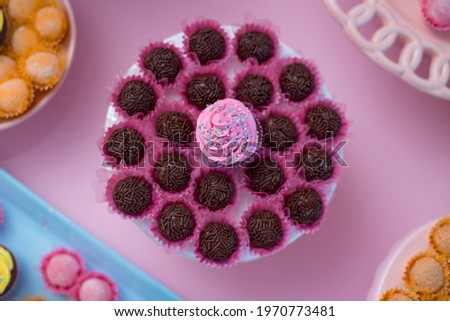 Chocolate candy and pink cupcake