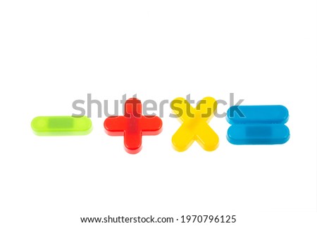 Mathematical signs from plastic marshmallow on white background.