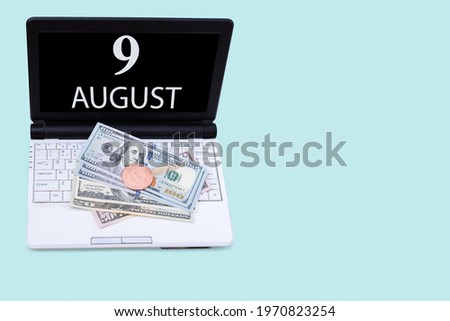 9th day of august. Laptop with the date of 9 august and cryptocurrency Bitcoin, dollars on a blue background. Buy or sell cryptocurrency. Stock market concept. Summer month, day of the year concept.