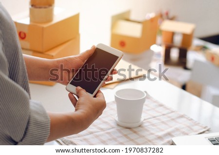 Owner of online seller taking product photos for uploading to website, online shop, young woman hand, concept of online sales, e-commerce