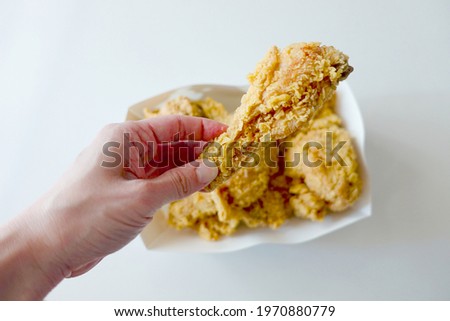 White background picture of holding a appetizing chicken.