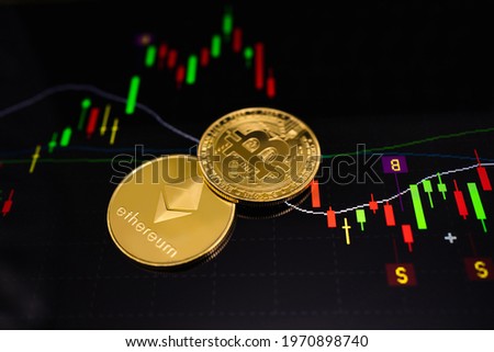 Gold Ethereum coin (ETH) and gold Bitcoin coin (BTC) with a graph chart. Trading on the cryptocurrency exchange. Cryptocurrency Stock Market Concept.