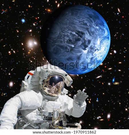 Astronaut and alien planet in deep space. The elements of this image furnished by NASA.