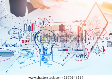 Woman hands typing on keyboard, laptop on office table. Double exposure of business graphs, arrows and financial analysis with lightbulb. Concept of business ideas