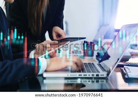 Two professional traides on technical price graph and indicator, red and green candlestick chart and stock trading computer at office
