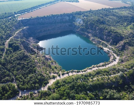 Black or Radon Lake in the Nikolaev region of Ukraine from a bird's eye view. Flooded granite quarry, aerial view, landscape.