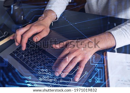 Hands typing the keyboard to create innovative software to change the world and provide a completely new service. Close up shot. Hologram tech graphs. Concept of Dev team.
