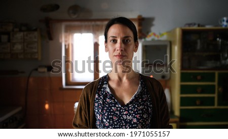 Portrait of poor mature woman indoors at home, poverty concept. Royalty-Free Stock Photo #1971055157