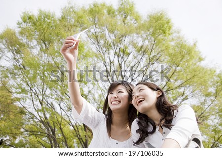 2 Women Taking A Picture For Email