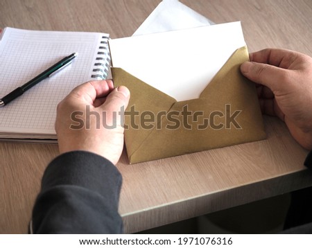 someone who opened the envelope on the table