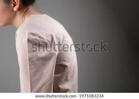 The woman has a stooped posture. Royalty-Free Stock Photo #1971083234