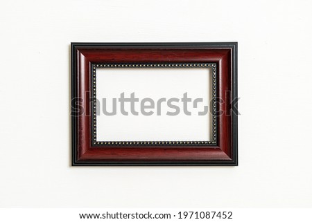 empty picture frame on white wall background with copy space