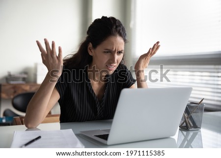 What is wrong. Anxious angry hispanic female splash hands unable to access database on laptop forgetting password having weak wifi signal. Mad shocked young woman worker losing job result on broken pc Royalty-Free Stock Photo #1971115385