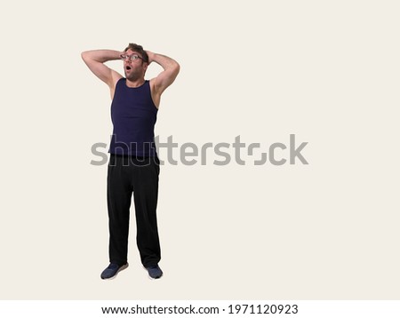 Man in blue tank top looks absolutely shocked