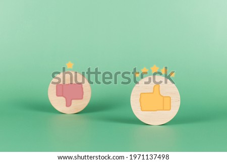 Wooden with thumbs up and five star rating icon on green background. Service rating, satisfaction concept