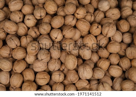 top down view of heap of brown walnuts background