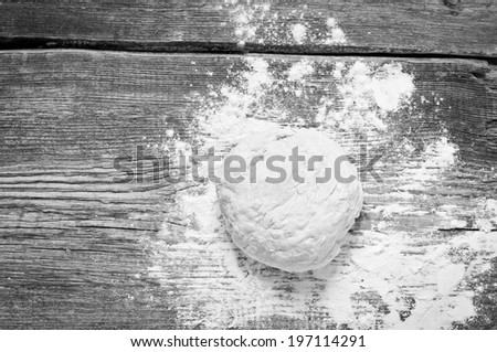  Prepared dough and dusting of flour on wooden background