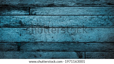 Old blue wood background with aged boards lined up. Wooden floor planks with grain and texture.