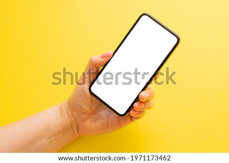 Mobile phone with empty white screen on yellow background