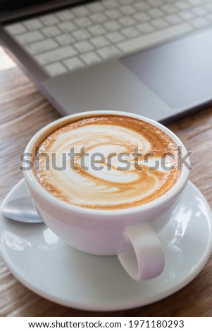 Morning coffee latte on wood desk work from home office, stock photo