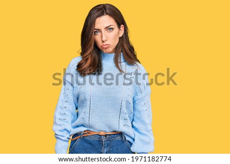 Young brunette woman wearing casual winter sweater depressed and worry for distress, crying angry and afraid. sad expression. 