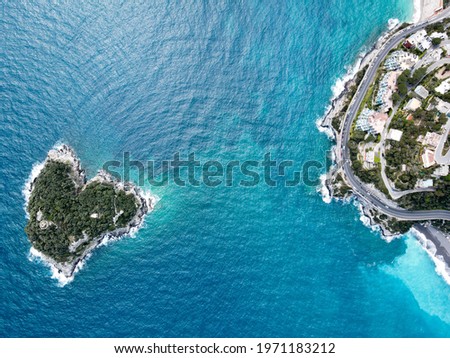 Aerial view of Bergeggi island, heart island from above, in Liguria, north Italy. Drone photography of the Ligurian coast, province of Savona with Spotorno and the island of Bergeggi, near Noli.