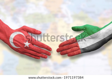 Turkey and United Arab Emirates - Flag handshake symbolizing partnership and cooperation Royalty-Free Stock Photo #1971197384