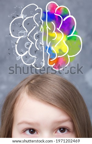 The girl has a brain drawn above her head, each hemisphere can work with something different. Royalty-Free Stock Photo #1971202469