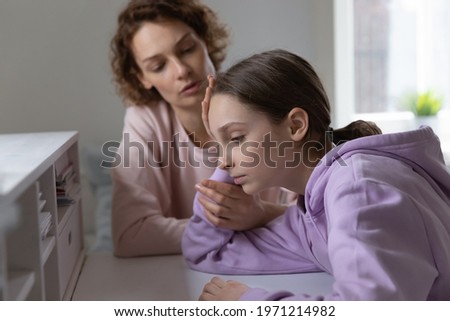 Affectionate mother giving psychological support to depressed young teen kid daughter. Stressed adolescent child girl feeling abused or suffering from bullying, parental help and devotion concept. Royalty-Free Stock Photo #1971214982