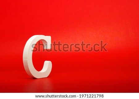 C white letter word wooden Isolated Red Background with Copy Space - Advertise object symbol or the third  grade competition Concept 