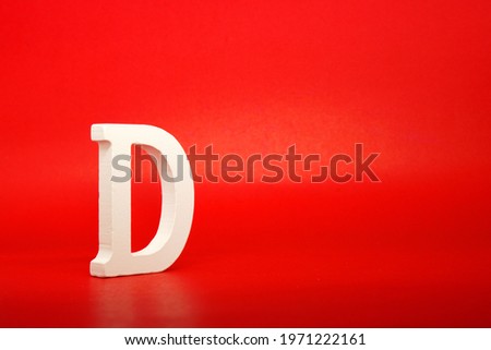 D white letter word wooden Isolated Red Background with Copy Space - Advertise object symbol or the last grade competition Concept 